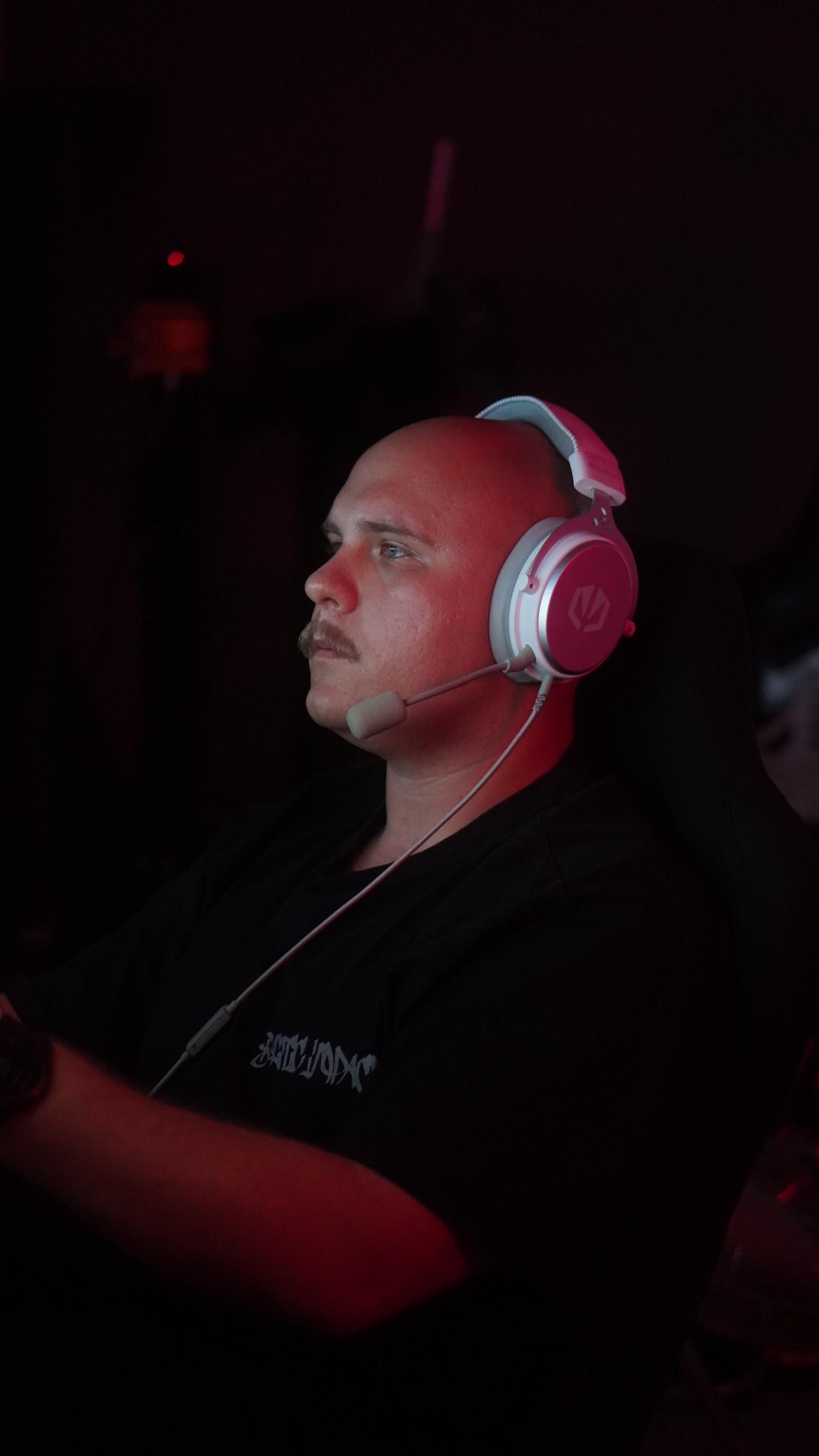 A driver in headphones at the wheel during a league race